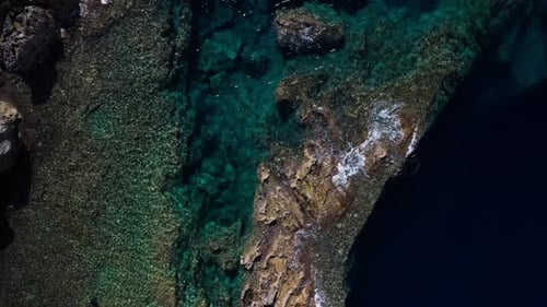 Drone aerial view of the Dwejra cliffs in Gozo, Malta, cinematic 60FPS footage showcasing dramatic