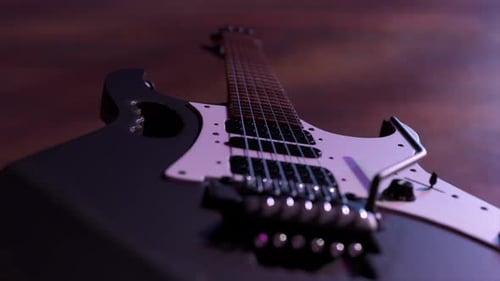 Closeup View of a Modern Electric Guitar with Six Strings Pickups and a Tremolo Bridge Illuminated