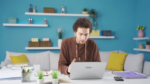 Man Working at Laptop Computer in Modern Home