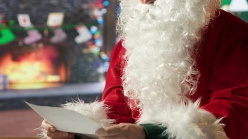 Santa Claus Reading a Letter by the Fireplace