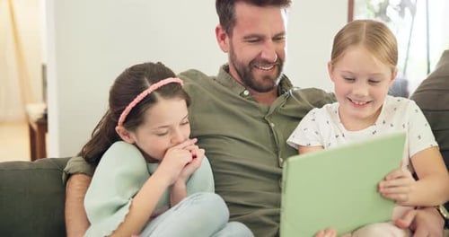 Father and Daughters Enjoying a Tablet Together