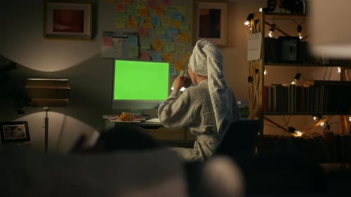 Person in Robe Uses Computer at Night