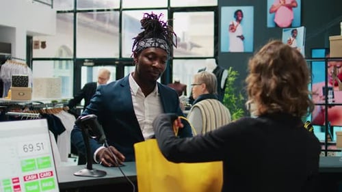 African American Client Paying with Card at Pos in Clothing Store