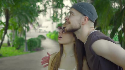 Affectionate Young Couple Admiring Park Scenery Together