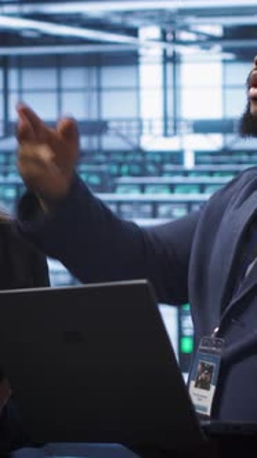 Vertical Video Coworkers in Data Center Doing Brainstorming Fixing Errors