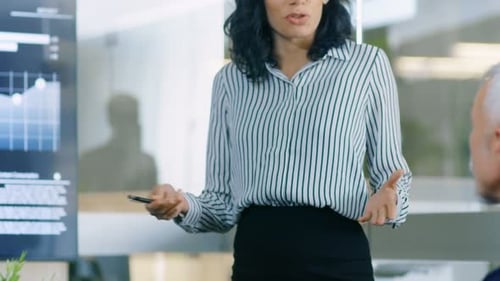 Business presentation with data graphs in a modern office