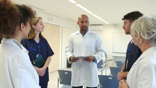 Medical Team Discussing Patient Status in Hospital Meeting Room