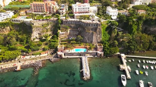 Aerial drone view of Sorrento sea coast with beaches and buildings, Italy