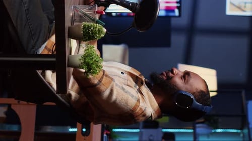 Vertical Video Show Host Recording Podcast with Guest Using Audio Recording Equipment in Home Studio