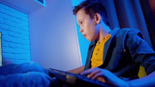 Boy Plays Video Game and Celebrates Victory