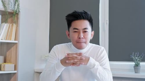 Young Adult Male Talking Indoors to Camera