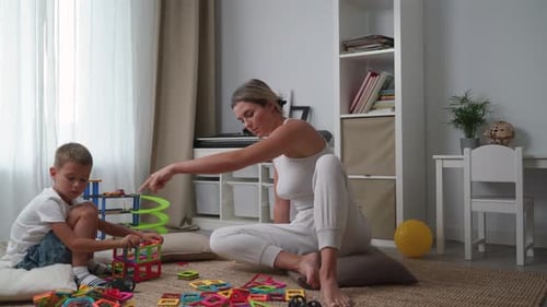 Mother and Son Building with Magnetic Blocks at Home