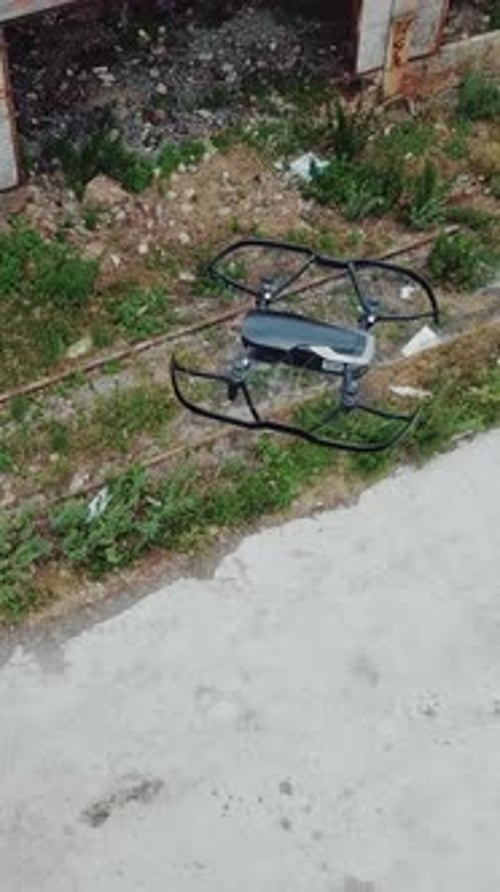 Drone flies over an abandoned factory. Aerial view of abandoned industrial buildings. Vertical video