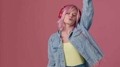 Woman with Pink Hair Dancing with Headphones