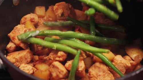 Adding Green Beans to Chicken and Potatoes Dish