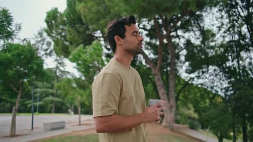 Stylish Man Standing Park Holding Beverage Takeaway Closeup Relaxed Italian Guy
