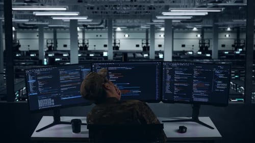 Back View Of Tired Asian Military Yawning While Write Code In Data Center