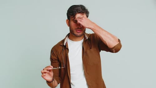 Young Man Takes off and Puts on Glasses