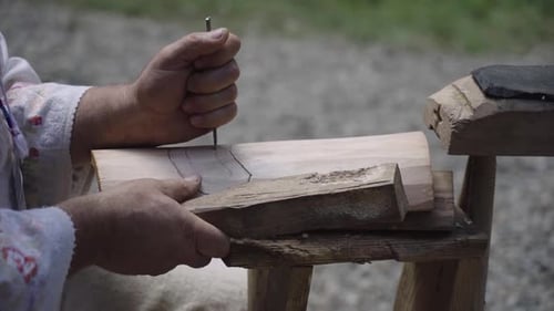 Woodworker carving intricate design in wooden piece