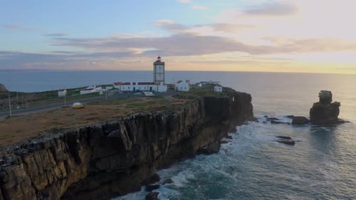 Aerial view of beautiful sunrise and light of the lighthouse.