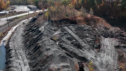 Strip mining in USA. Pile of black anthracite coal on mountain. American fossil fuel reliance. Home