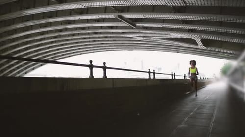 Young adult female running in city of London