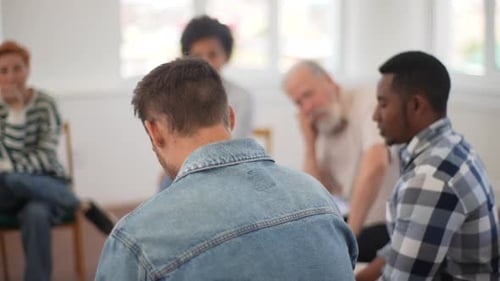 Closeup Back View of Unrecognizable Sad Man Sharing Life Problem Grief with Multiracial People in