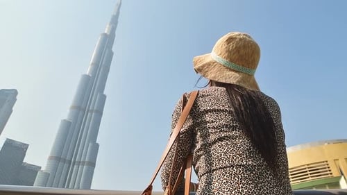 Woman Tourist Gaze Up To Burj Khalifa Top