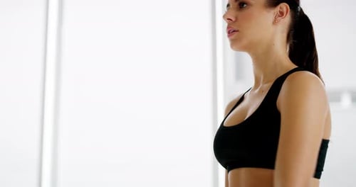 Woman Doing Dumbbell Exercise in Gym