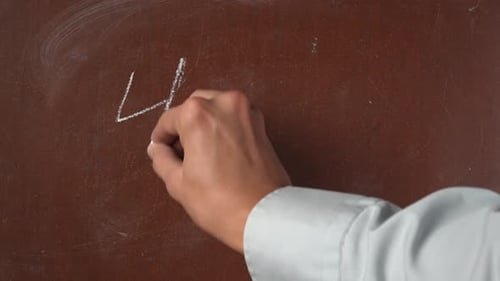 Hand Writing Simple Math Equation on Chalkboard