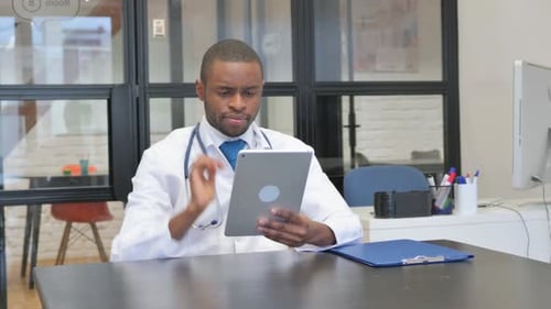 African Male Doctor Using Digital Tablet