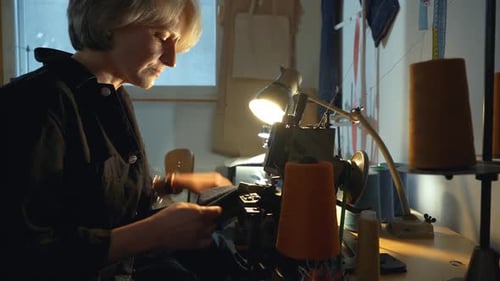 Woman Sewing Fabric at a Sewing Machine