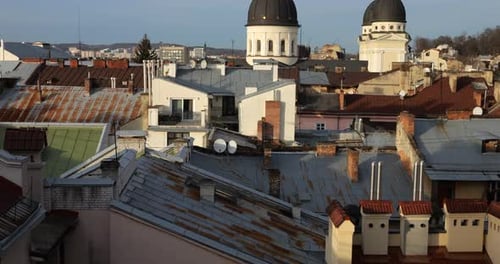 Architecture of an old European city. Shooting tiled roofs and chimneys.