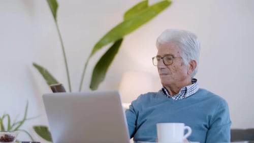 Senior Man Takes Selfie in Bright Home