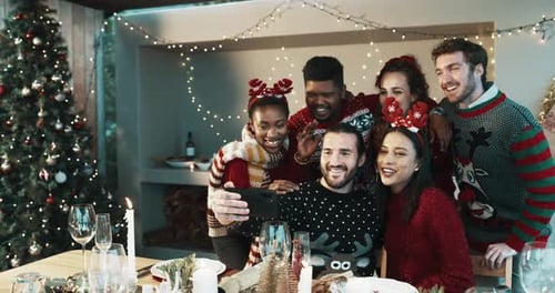 Friends Taking Festive Selfies at Christmas Dinner