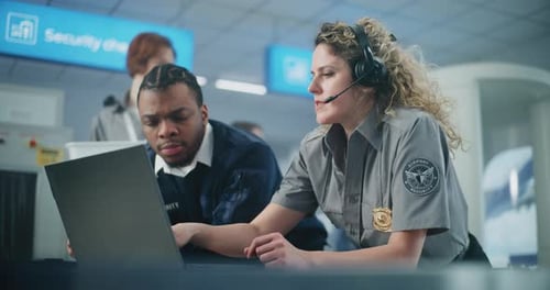 Airport Security Team Reviewing Information on Laptop