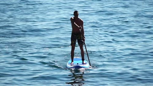 Man Sup Sea Strong Athletic Man Learns to Paddle Sup Standing on Board in Open Sea Ocean on Sunny