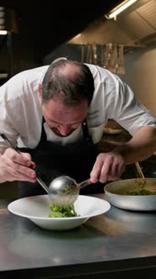 Chef Plating Fine Cuisine in Restaurant Kitchen