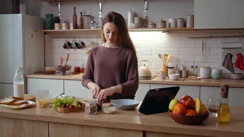 Woman Prepares Healthy Meal in Bright Kitchen
