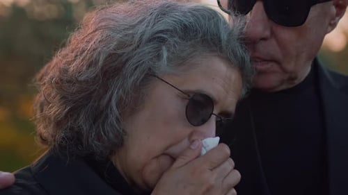 Mature Couple Comforting Each Other Outdoors at Sunset
