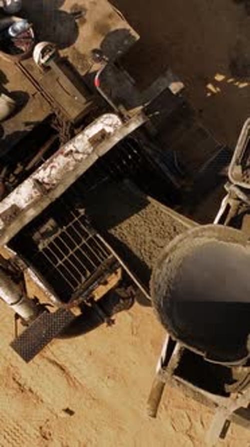 Aerial Vertical Close Up Concrete Mixer Pouring into Pump