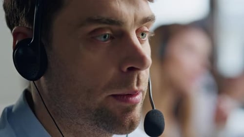 Close-Up of Man Wearing Headset Talking at Work