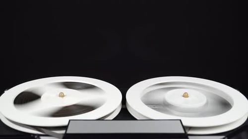 Reels of Audio Magnetic Tape Spinning Quickly