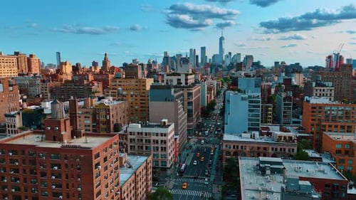 Lots of cars on the road of New York, USA. Group of gorgeous skyscrapers in Manhattan at backdrop.
