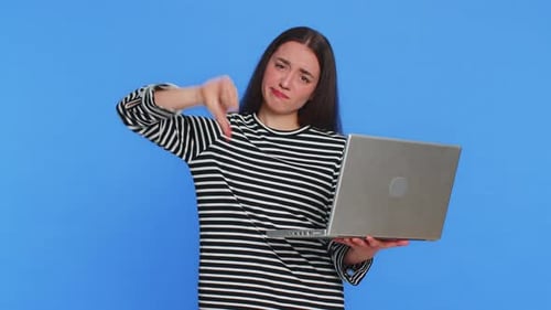 Young Woman Expressing Frustration Using Laptop Computer