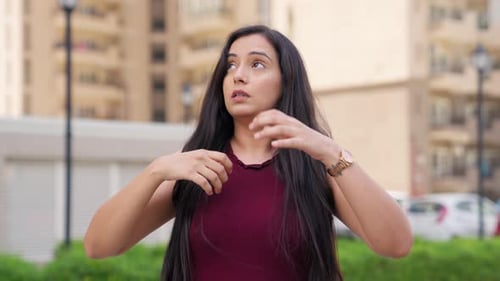 Woman Outdoors Rubbing Irritated Face and Neck