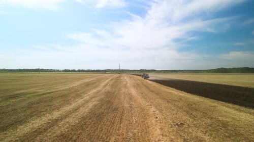 Tractors plowing the field in Ukraine