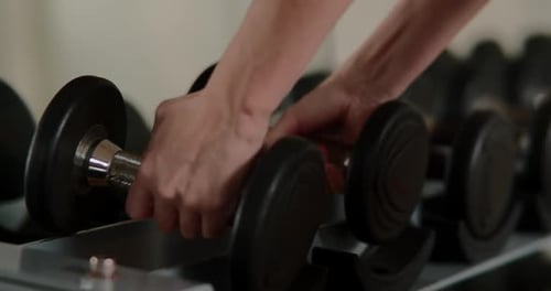 Female Hands Taking Bodybuilding Dumbbells in Gym Club Close Up Woman Hands Taking Weight Lifting in