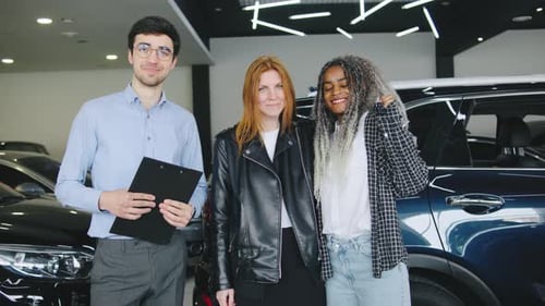 Happy Women Buy New Car From Salesman