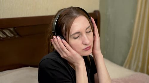 Cheerful Joyful Woman in Headphones Listening to Music and Dancing Close Up Portrait Happy Upbeat